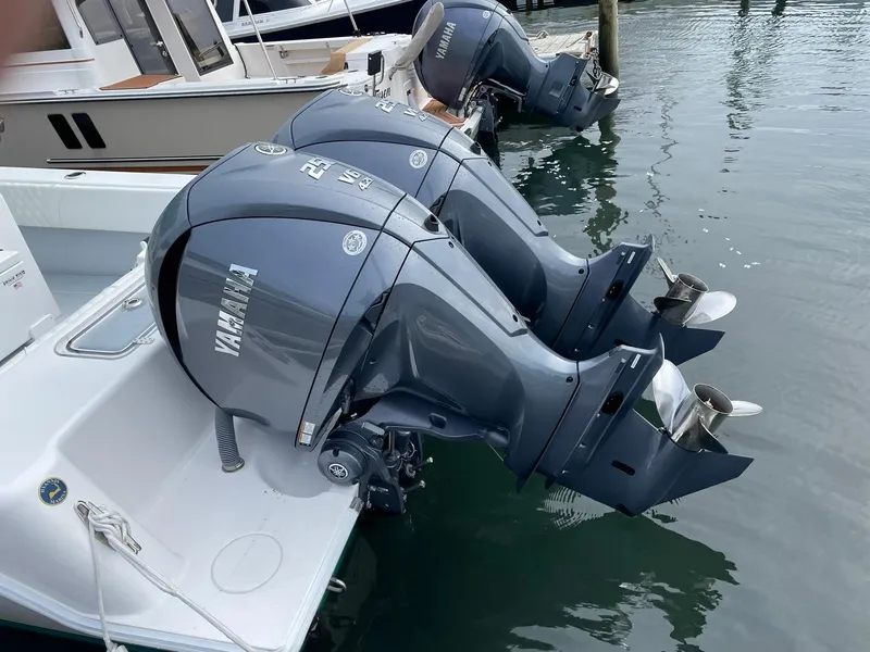 Slide: The Image of 2024 Contender 28 Tournament with dual Yamaha outboard motors docked in marina. - 11