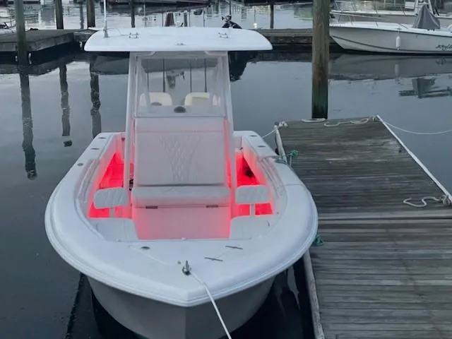 Slide: The Image of 2024 Contender 28 Tournament boat docked, featuring red interior lighting. - 12