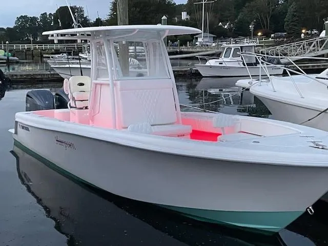 Slide: The Image of 2024 Contender 28 Tournament boat docked, featuring sleek design and illuminated interior. - 14