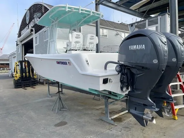 Slide: The Image of 2024 Contender 28 Tournament boat with dual Yamaha engines at a marina. - 17