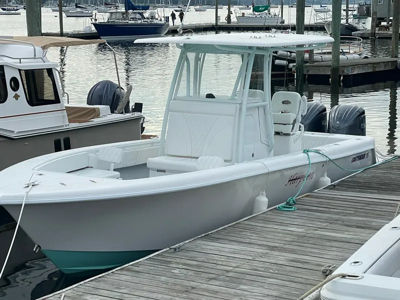 Slide: The Image of 2024 Contender 28 Tournament boat docked at marina, featuring sleek design and twin engines. - 3