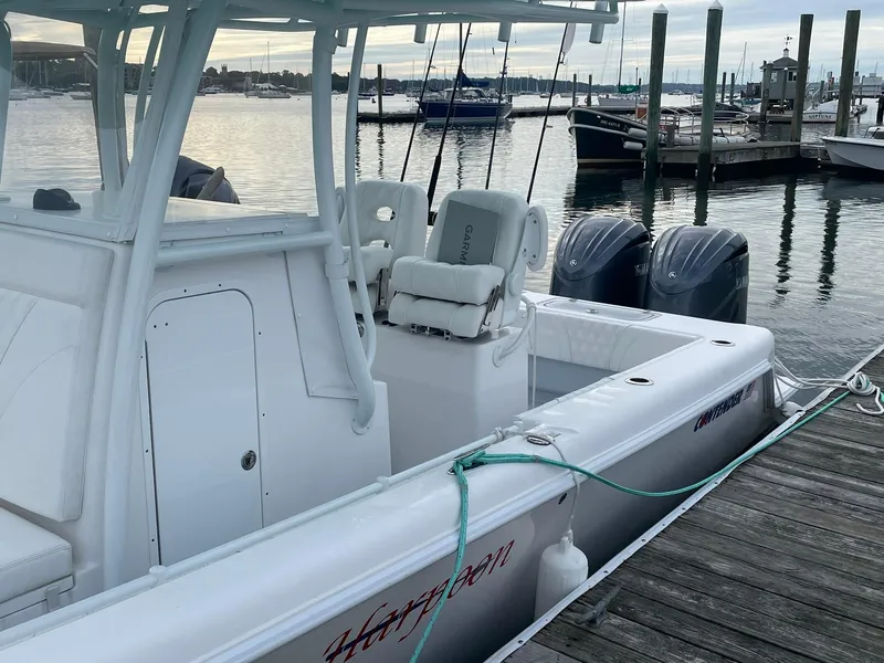 Slide: The Image of 2024 Contender 28 Tournament boat docked, featuring dual engines and sleek design. - 5