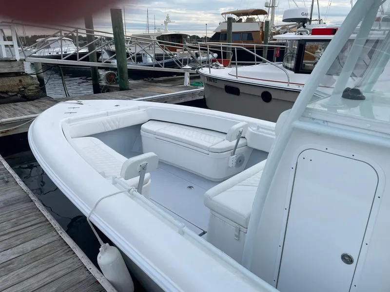 Slide: The Image of 2024 Contender 28 Tournament boat docked, featuring spacious seating and sleek design. - 6