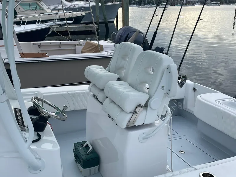 Slide: The Image of 2024 Contender 28 Tournament boat interior with white seating and fishing rods. - 8
