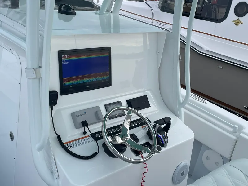 Slide: The Image of 2024 Contender 28 Tournament helm with Garmin display and steering wheel. - 9