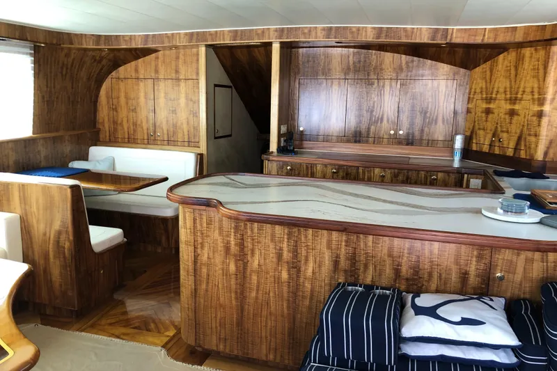 Slide: The Image of Luxurious 1999 Hines-Farley SPORTFISHERMAN yacht interior with elegant wood finish and cozy seating. - 12