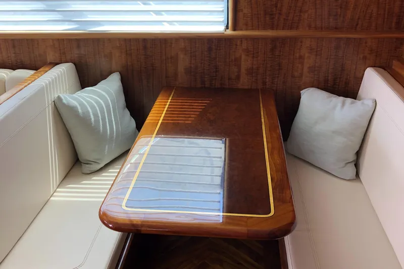 Slide: The Image of Luxurious 1999 Hines-Farley SPORTFISHERMAN yacht interior with elegant wood table and cushioned seating. - 13