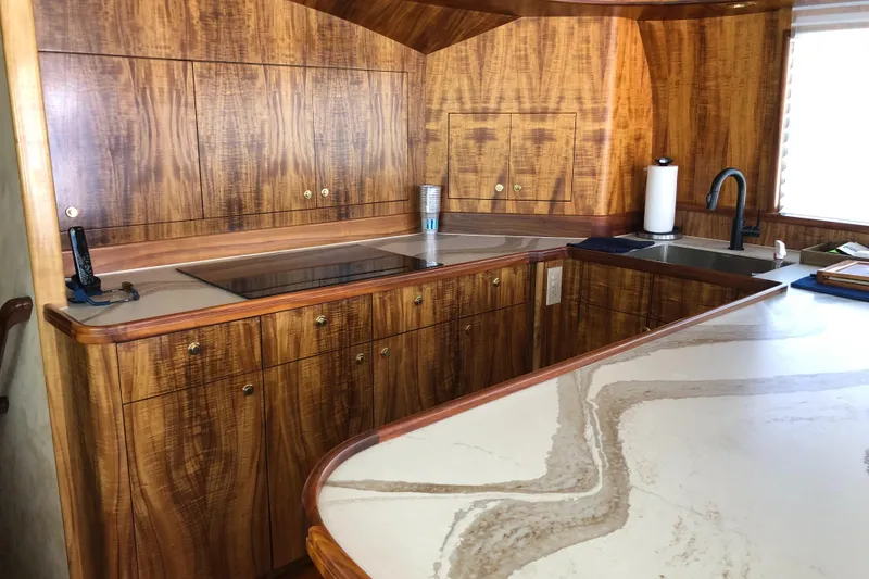 Slide: The Image of Luxurious wood-paneled kitchen in 1999 Hines-Farley SPORTFISHERMAN yacht with modern amenities. - 14