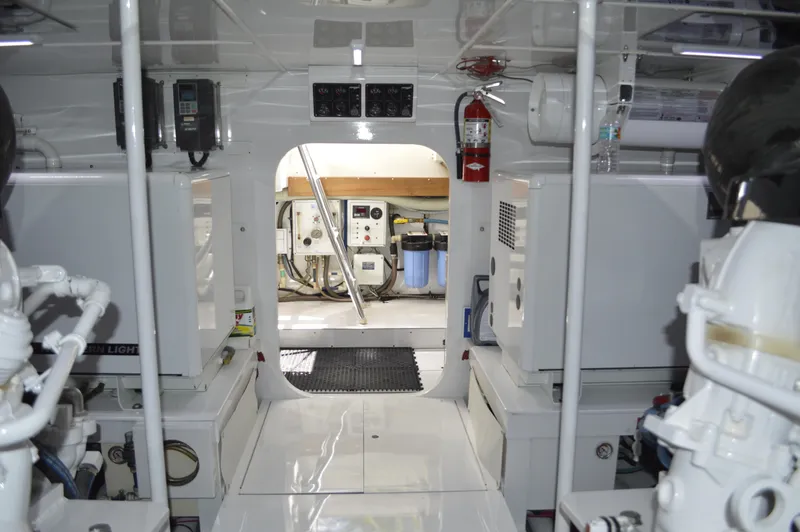 Slide: The Image of Engine room of 1999 Hines-Farley SPORTFISHERMAN boat, featuring equipment and fire extinguisher. - 20