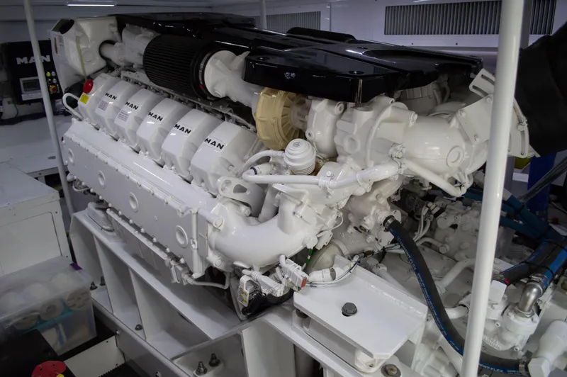 Slide: The Image of Engine of a 1999 Hines-Farley SPORTFISHERMAN boat, showcasing detailed mechanical components. - 21