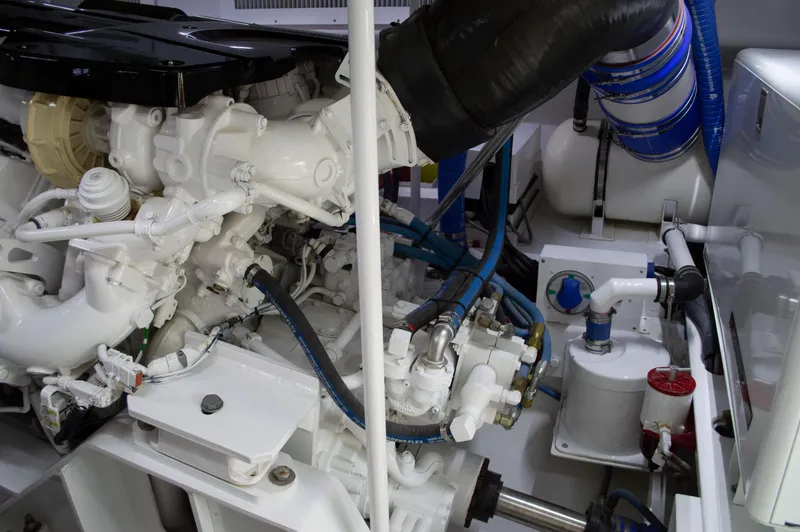 Slide: The Image of Engine room of a 1999 Hines-Farley SPORTFISHERMAN boat, showcasing mechanical components. - 22