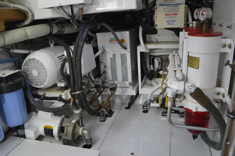 Slide: The Image of Engine room of a 1999 Hines-Farley SPORTFISHERMAN with various mechanical components. - 23