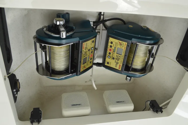 Slide: The Image of 1999 Hines-Farley SPORTFISHERMAN fishing reels and equipment in storage compartment. - 27