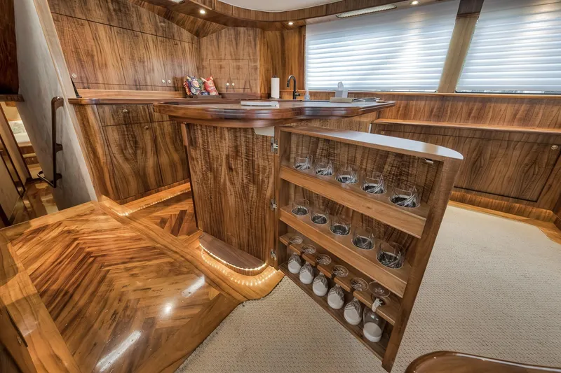 Slide: The Image of Luxurious 1999 Hines-Farley SPORTFISHERMAN yacht interior with elegant wood cabinetry and built-in glassware storage. - 33