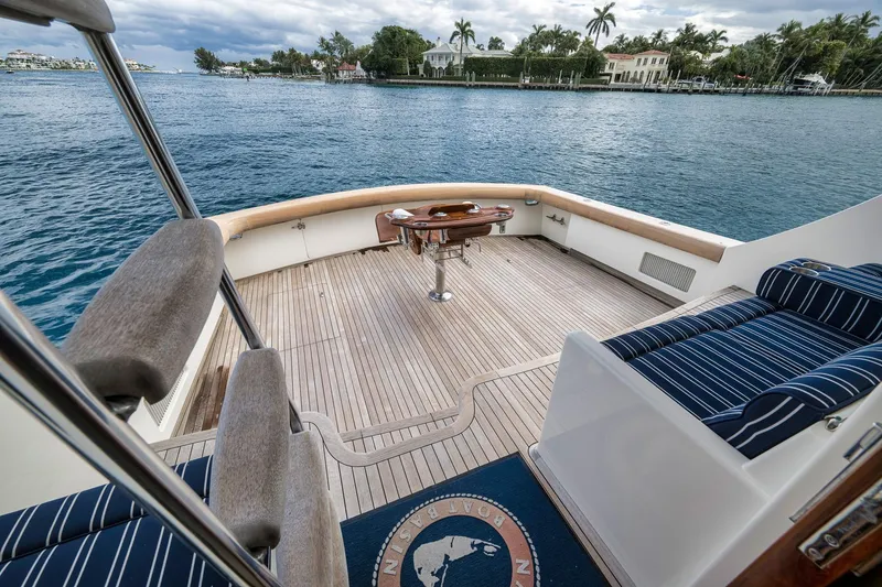 Slide: The Image of 1999 Hines-Farley SPORTFISHERMAN yacht deck with seating, overlooking serene waterfront. - 34