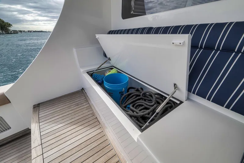 Slide: The Image of 1999 Hines-Farley SPORTFISHERMAN boat storage with ropes and bucket, docked by the water. - 37