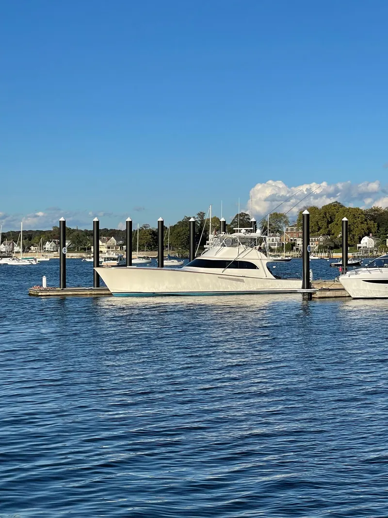 Slide: The Image of 1999 Hines-Farley SPORTFISHERMAN yacht docked in a serene marina setting. - 4