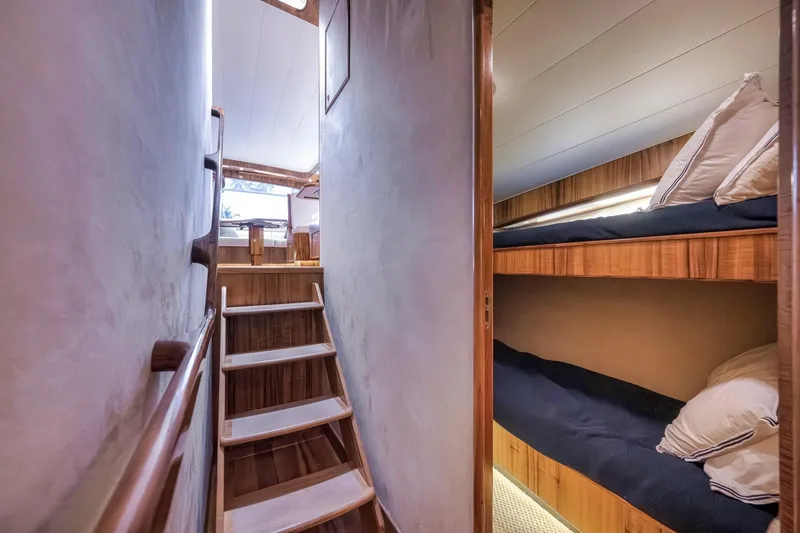 Slide: The Image of Interior of 1999 Hines-Farley SPORTFISHERMAN yacht with wooden stairs and cozy bunk beds. - 55