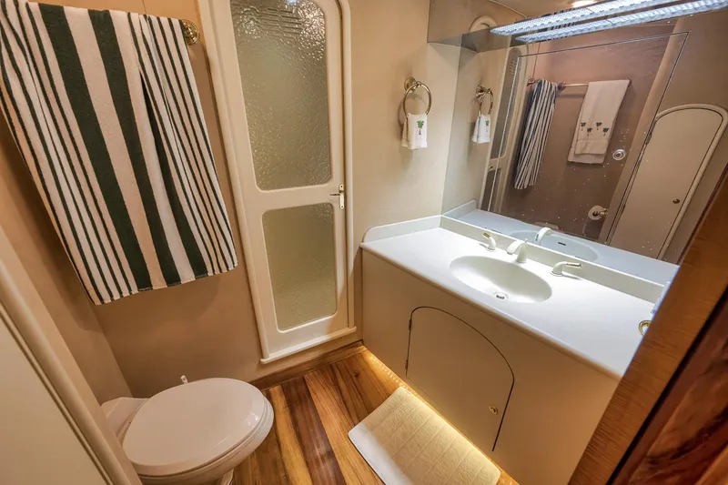 Slide: The Image of Bathroom interior of 1999 Hines-Farley SPORTFISHERMAN yacht with modern fixtures and striped towel. - 56
