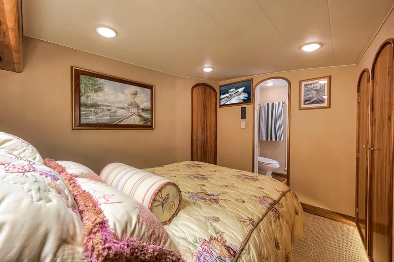 Slide: The Image of Luxurious 1999 Hines-Farley SPORTFISHERMAN yacht bedroom with elegant decor and en-suite bathroom. - 57