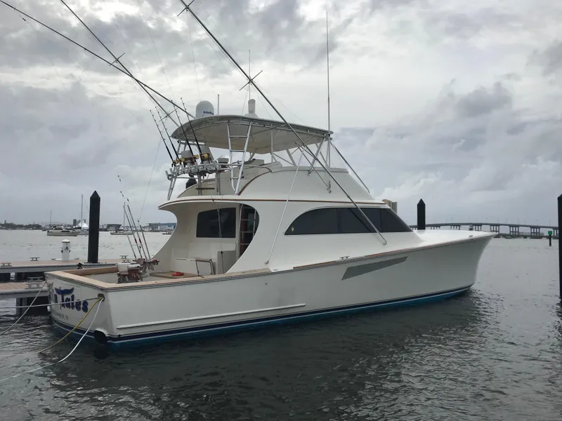 Slide: The Image of 1999 Hines-Farley SPORTFISHERMAN yacht docked in a marina under cloudy skies. - 6