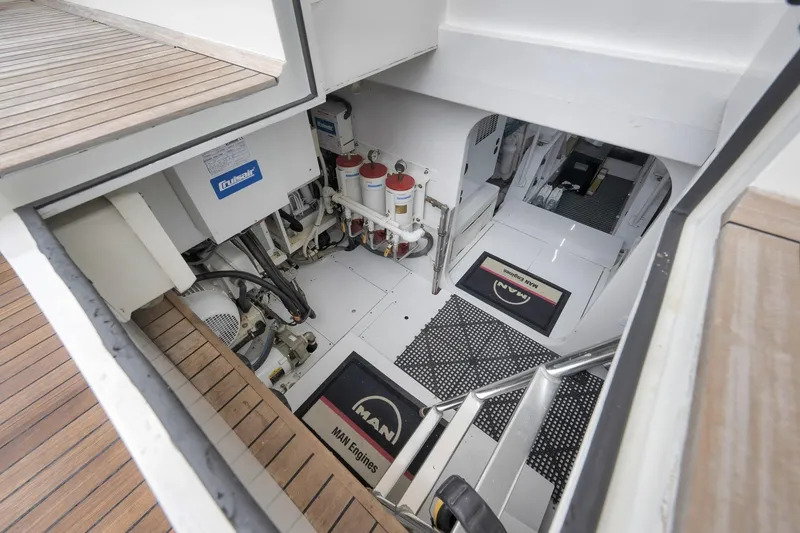 Slide: The Image of Engine room of 1999 Hines-Farley SPORTFISHERMAN with visible equipment and wooden deck. - 63