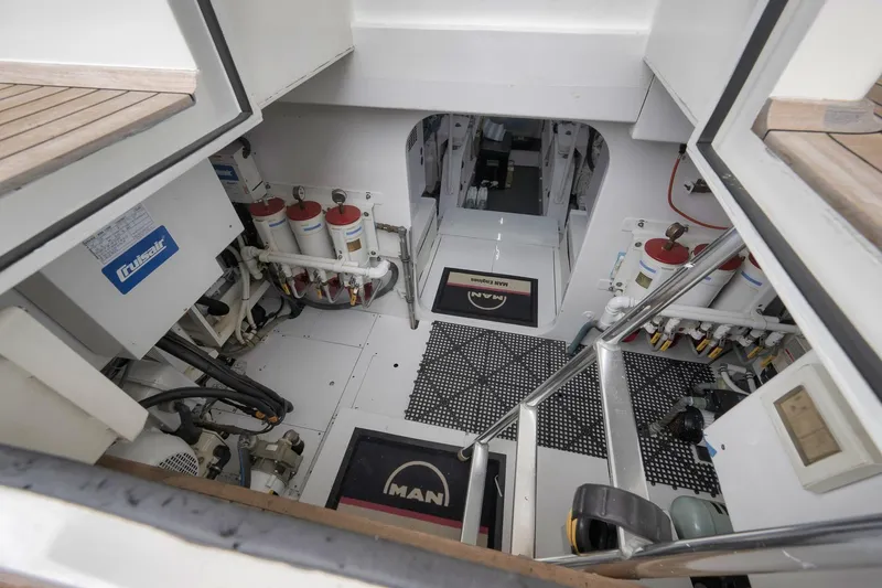 Slide: The Image of Engine room of 1999 Hines-Farley SPORTFISHERMAN yacht, featuring mechanical equipment and systems. - 64