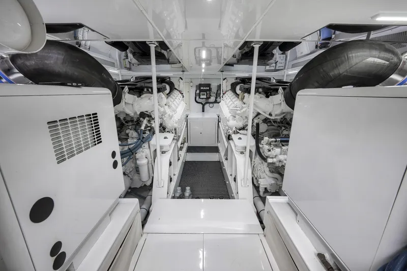 Slide: The Image of Engine room of a 1999 Hines-Farley SPORTFISHERMAN, showcasing dual engines and mechanical components. - 68