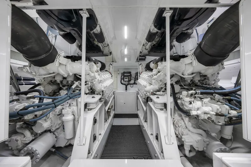 Slide: The Image of Engine room of 1999 Hines-Farley SPORTFISHERMAN yacht, showcasing dual engines and mechanical systems. - 69