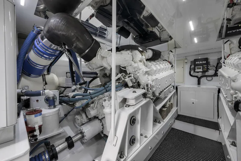 Slide: The Image of Engine room of 1999 Hines-Farley SPORTFISHERMAN yacht with MAN engines and blue hoses. - 70
