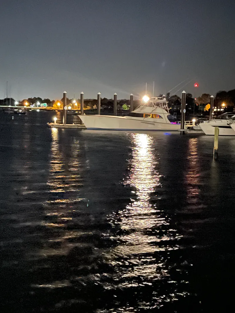 Slide: The Image of 1999 Hines-Farley SPORTFISHERMAN yacht docked at night, reflecting on calm water. - 8
