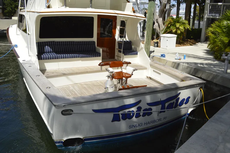 Slide: The Image of 1999 Hines-Farley SPORTFISHERMAN boat docked, featuring spacious deck and seating area. - 9