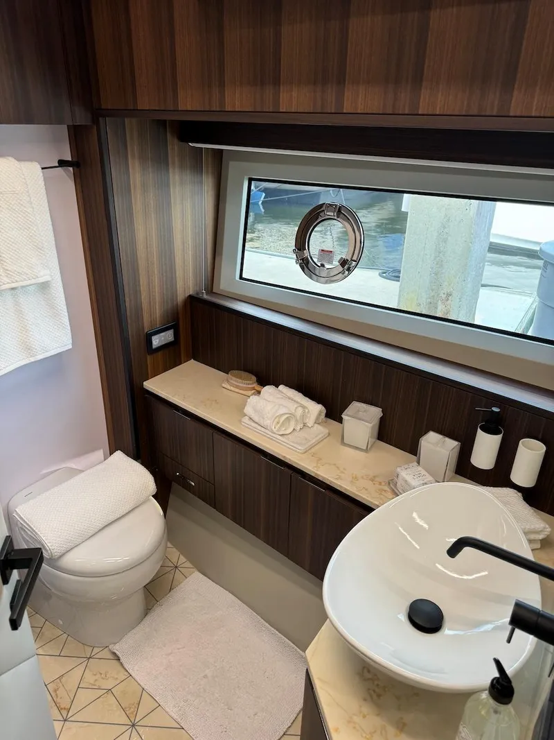 Slide: The Image of Luxurious bathroom in 2024 Aicon 66 Vivere yacht with modern fixtures and elegant wood finishes. - 33