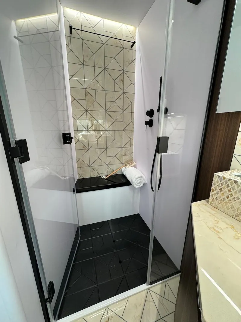Slide: The Image of Luxurious shower in 2024 Aicon 66 Vivere yacht with modern geometric tiles. - 36