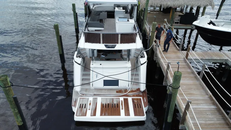 Slide: The Image of Aerial view of 2024 Aicon 66 Vivere yacht docked at a marina. - 4