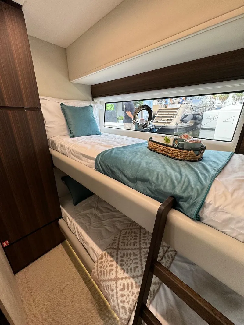 Slide: The Image of 2024 Aicon 66 Vivere yacht cabin with bunk beds and window view. - 41