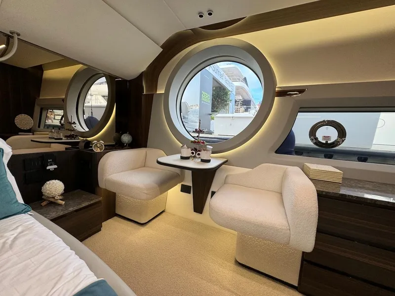 Slide: The Image of Luxurious interior of 2024 Aicon 66 Vivere yacht with elegant seating and round windows. - 48