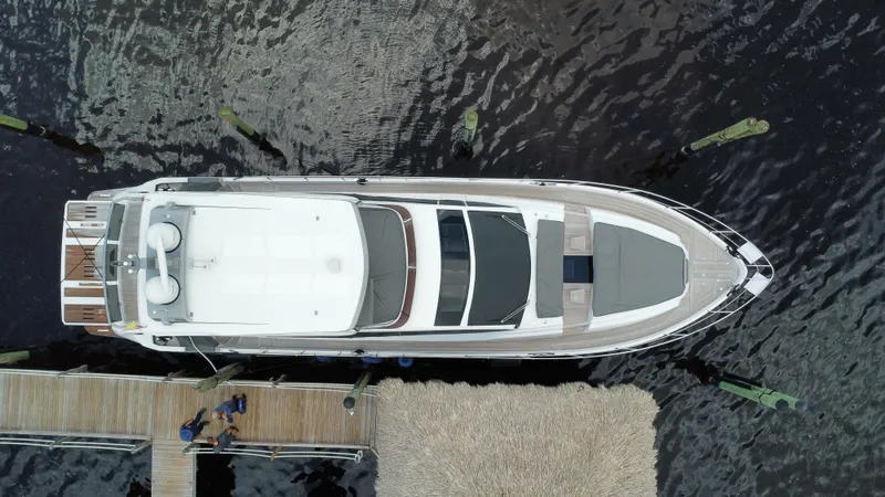 Slide: The Image of Aerial view of 2024 Aicon 66 Vivere luxury yacht docked at a marina. - 5