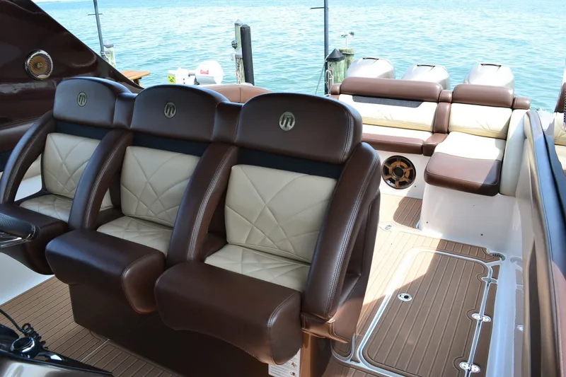 Slide: The Image of Luxurious seating on 2016 Mystic Powerboats M4200, featuring elegant brown and cream upholstery. - 14