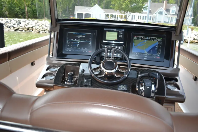 Slide: The Image of Cockpit of 2016 Mystic Powerboats M4200 with advanced navigation displays and controls. - 15