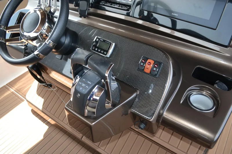 Slide: The Image of 2016 Mystic Powerboats M4200 helm with modern controls and carbon fiber accents. - 17