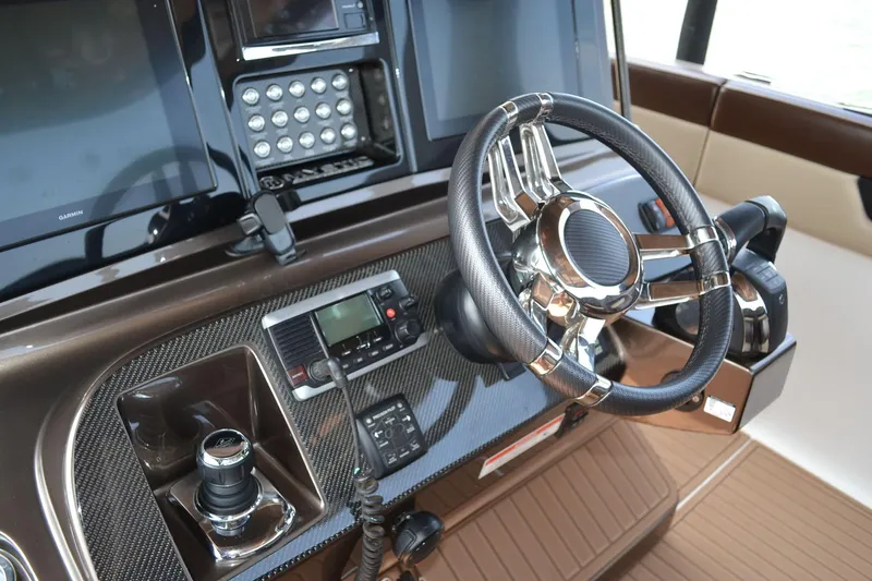 Slide: The Image of 2016 Mystic Powerboats M4200 helm with modern controls and sleek steering wheel. - 18