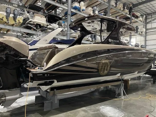 Slide: The Image of 2016 Mystic Powerboats M4200 in storage, sleek design, luxury motorboat. - 3