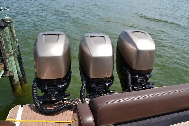 Slide: The Image of 2016 Mystic Powerboats M4200 with triple outboard engines on water. - 4