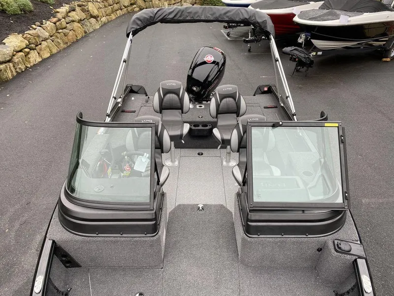 Slide: The Image of 2025 Lund 1775 Impact XS Sport boat with open cockpit and seating. - 11