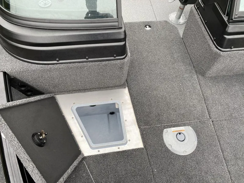 Slide: The Image of 2025 Lund 1775 Impact XS Sport boat interior with storage compartments and seating area. - 15