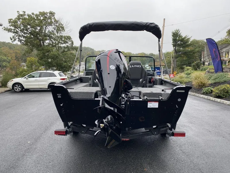 Slide: The Image of 2025 Lund 1775 Impact XS Sport boat with outboard motor on trailer. - 4