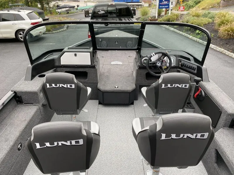 Slide: The Image of 2025 Lund 1775 Impact XS Sport boat interior with four seats and steering console. - 7