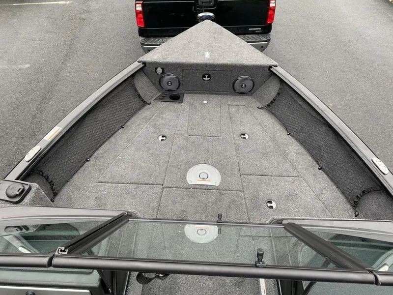 Slide: The Image of 2025 Lund 1775 Impact XS Sport boat interior, spacious deck with storage compartments. - 8