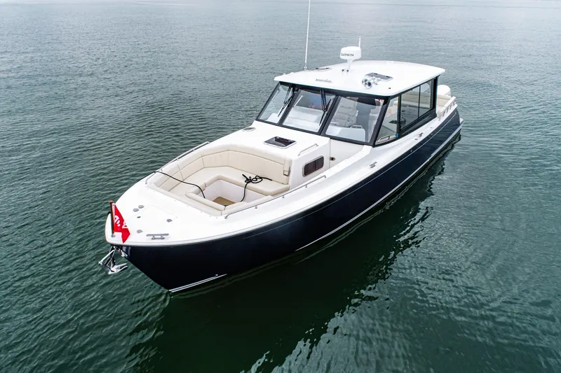 Slide: The Image of 2024 MJM 4 boat on calm water, featuring sleek design and spacious deck. - 1